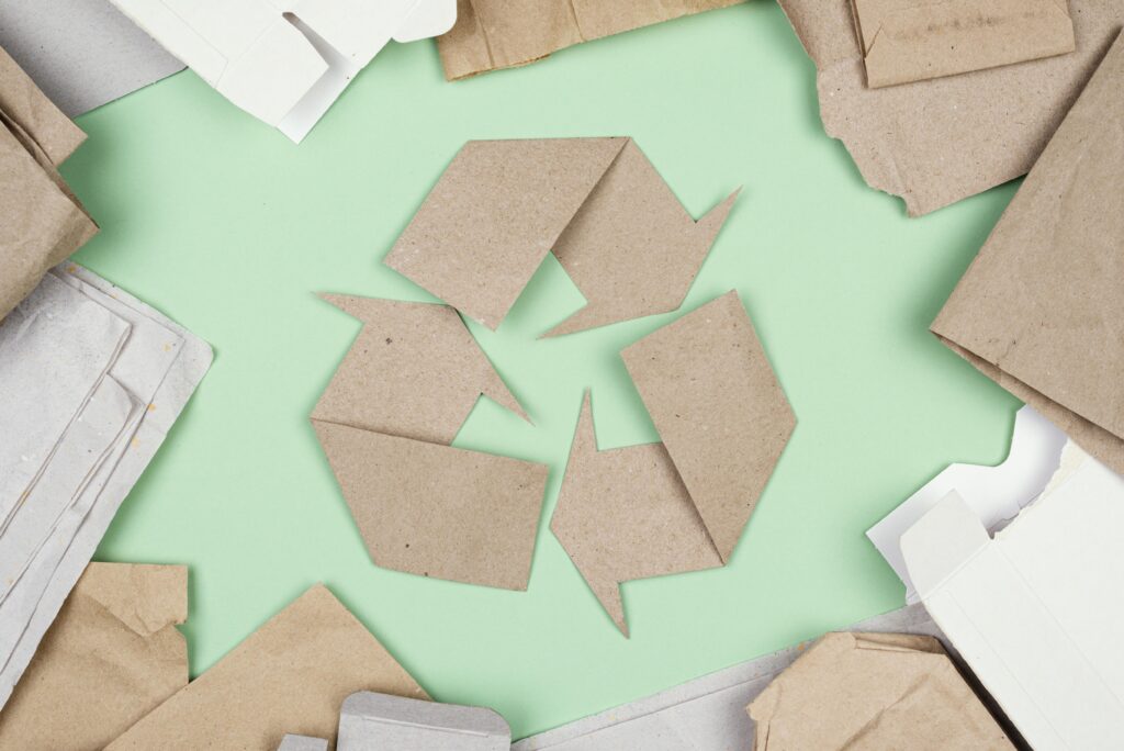EU Packaging Regulation cardboard shaped into recycling triangle symbol showing packaging waste recycling