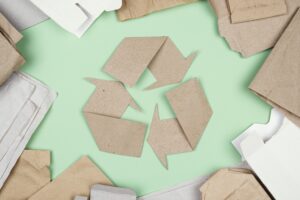 EU Packaging Regulation cardboard shaped into recycling triangle symbol showing packaging waste recycling