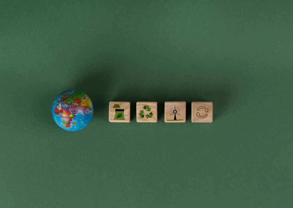 ESG software market illustration featuring a digital globe and four ESG-themed squares with sustainability and governance symbols